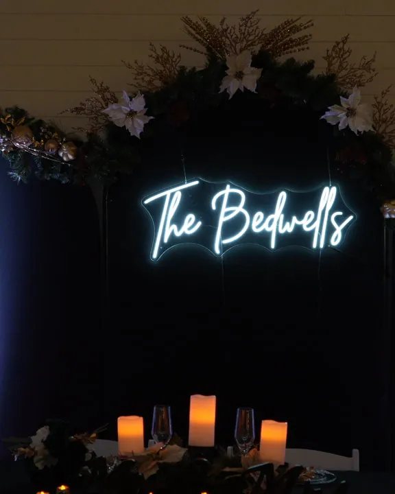 A neon sign glowing over the sweetheart table