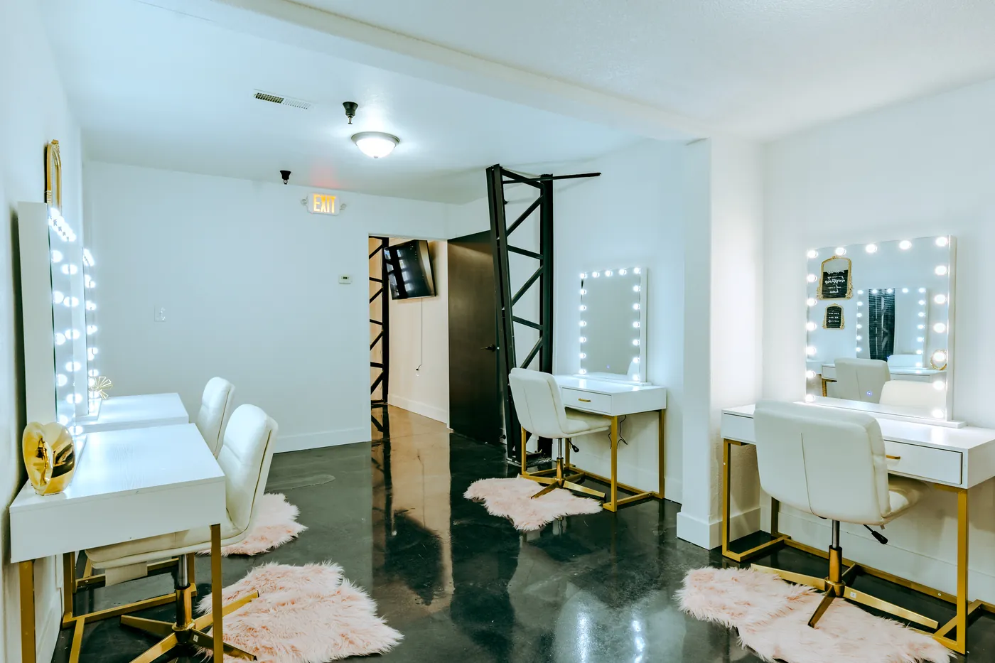 The Loft 102 getting-ready vanity stations with lit Hollywood mirrors